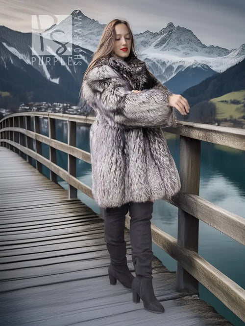 Silver fox fur coat with voluminous sleeves and wide collar, knee-length cut.