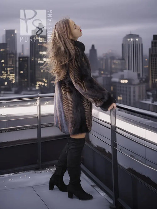 Women's two-tone mink jacket with long sleeves, dark fur and tan herringbone accents on front.
