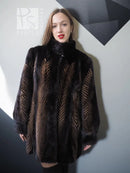 Women's two-tone mink jacket with stand collar, dark fur and tan herringbone vertical pattern.
