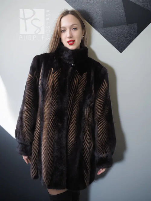 Women's two-tone mink jacket with stand collar, dark fur and tan herringbone vertical pattern.