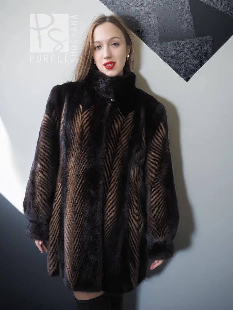 Women's two-tone mink jacket with stand collar, dark fur and tan herringbone vertical pattern.