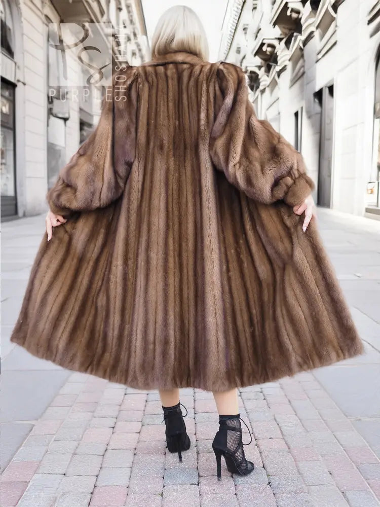 Back view of dark brown mink fur coat showing seams and voluminous sleeves