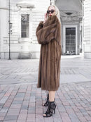 Brown fur mink coat with high collar, button front, and long sleeves on model