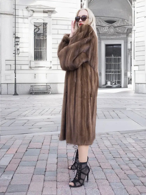 Brown fur mink coat with high collar, button front, and long sleeves on model
