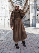 Dark brown mink fur coat with hood, long hem, and voluminous puff sleeves