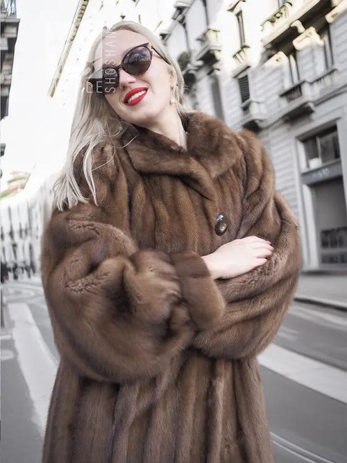 Brown fur mink coat close-up with high collar and button front