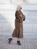 Dark brown mink fur coat with hood, long hem and full sleeves, side profile