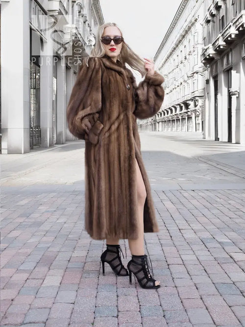 Dark brown mink fur coat with hood, full length with gathered waist seam, standing