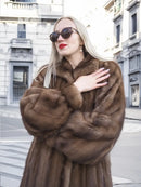 Brown fur mink coat with high collar, button front, and long sleeves