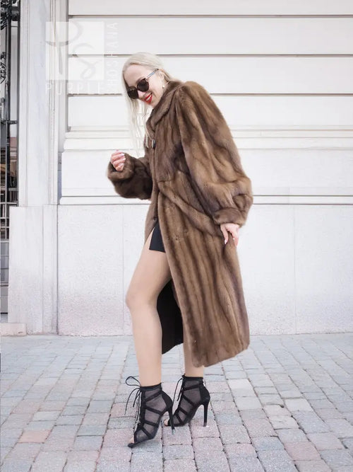 Dark brown mink fur coat with hood and wide sleeves, front view with crossed arms