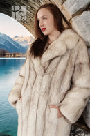 Cream faux-fur coat with notched collar, long sleeves, and textured plush detail.