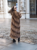 Long mink fur coat in espresso brown with swing back, button front, viewed from the side.