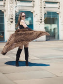 Long mink coat with wide swing hem and textured fur, draped to the side