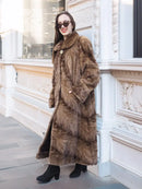 Long mink swing coat with standing collar and button closure, textured fur sleeves