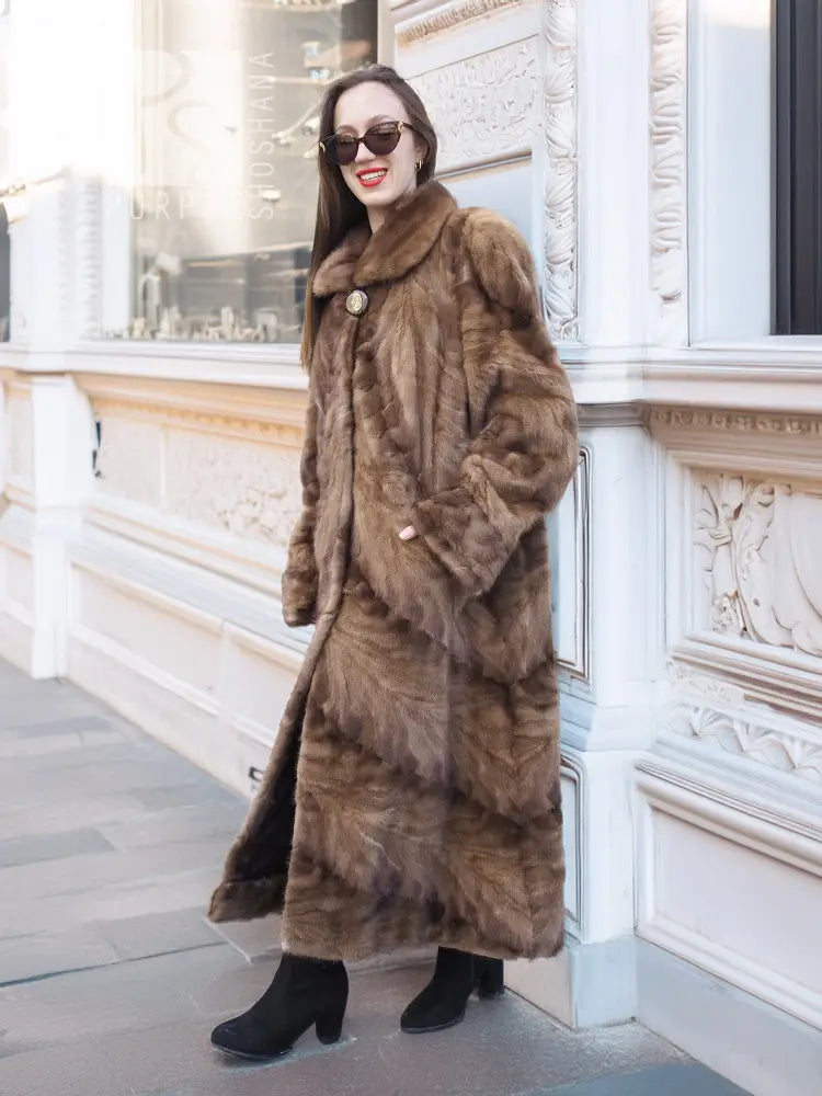 Long mink swing coat with standing collar and button closure, textured fur sleeves