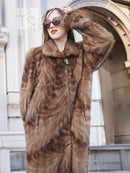Long mink fur coat with espresso-brown texture, buttoned front and raised shawl collar.
