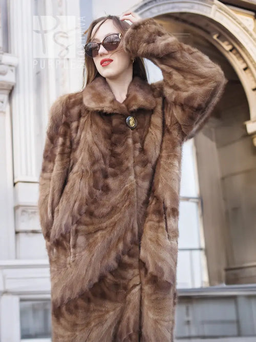 Long mink fur coat with espresso-brown texture, buttoned front and raised shawl collar.