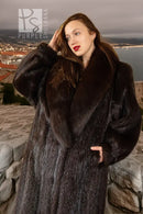 Dark beaver fur coat with plush fox collar, side view with hands near the cuffs