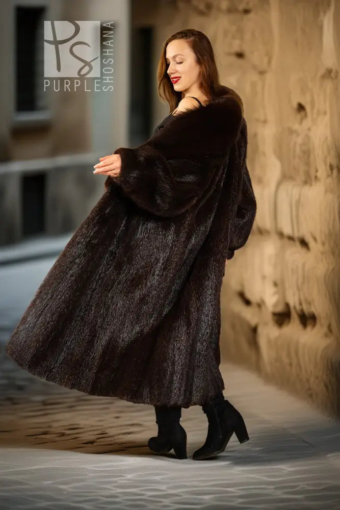 Back view of dark brown fur coat with wide hood-like collar and long, flared hem