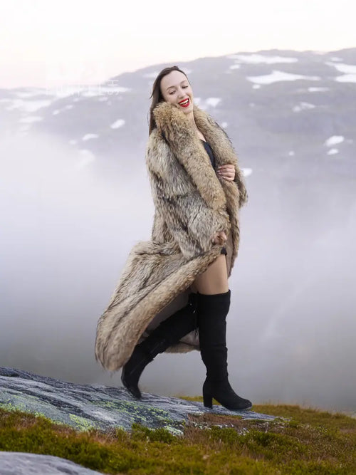 Raccoon fur coat with shawl collar, long flowing silhouette, open front, tan fur.