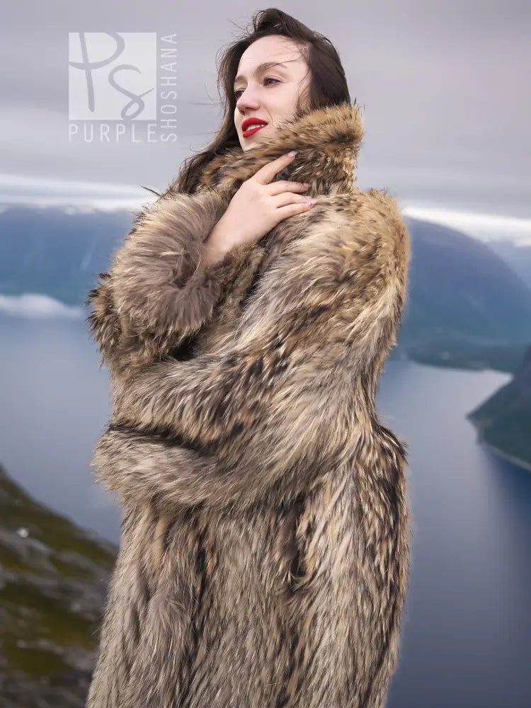 Long tan raccoon fur coat with shawl collar, open front, close-up from shoulders up.