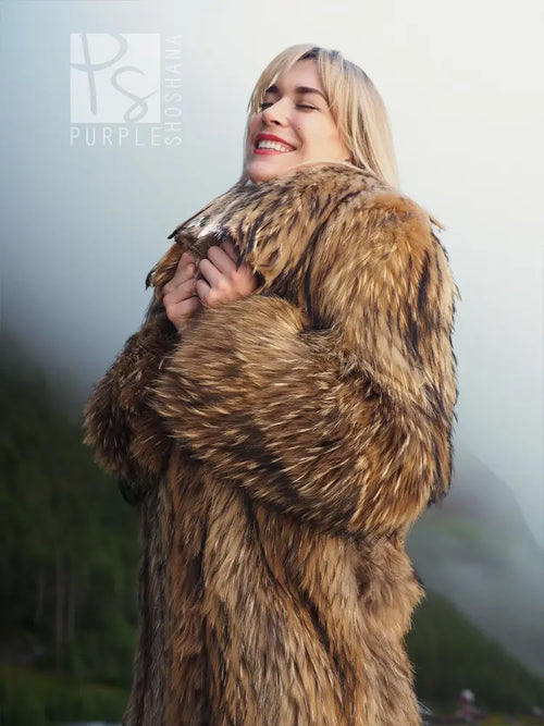 Brown raccoon fur coat with large hood and plush shawl-like shoulder wrap