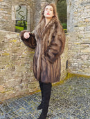 Long sable fur coat with side pockets and shaggy fur texture, brown