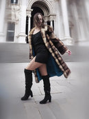 Vintage fur coat with horizontal striped design and open front, worn with boots