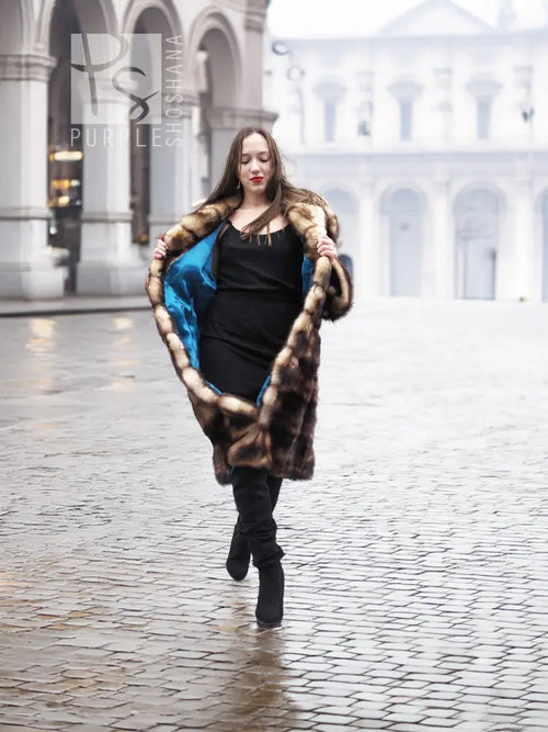 Vintage fur coat with horizontal striped fur panels and hood, mid-calf length