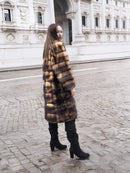 Vintage fur coat with brown and tan striped fur, side view, knee-length