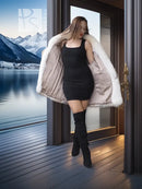White/tan fur short jacket with long sleeves, worn over black dress