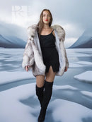 Light gray fur coat with plush sculptural collar, open front over black mini dress