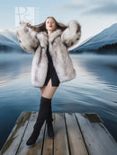 Light gray fur coat with wide sculptural collar, open front over black mini dress