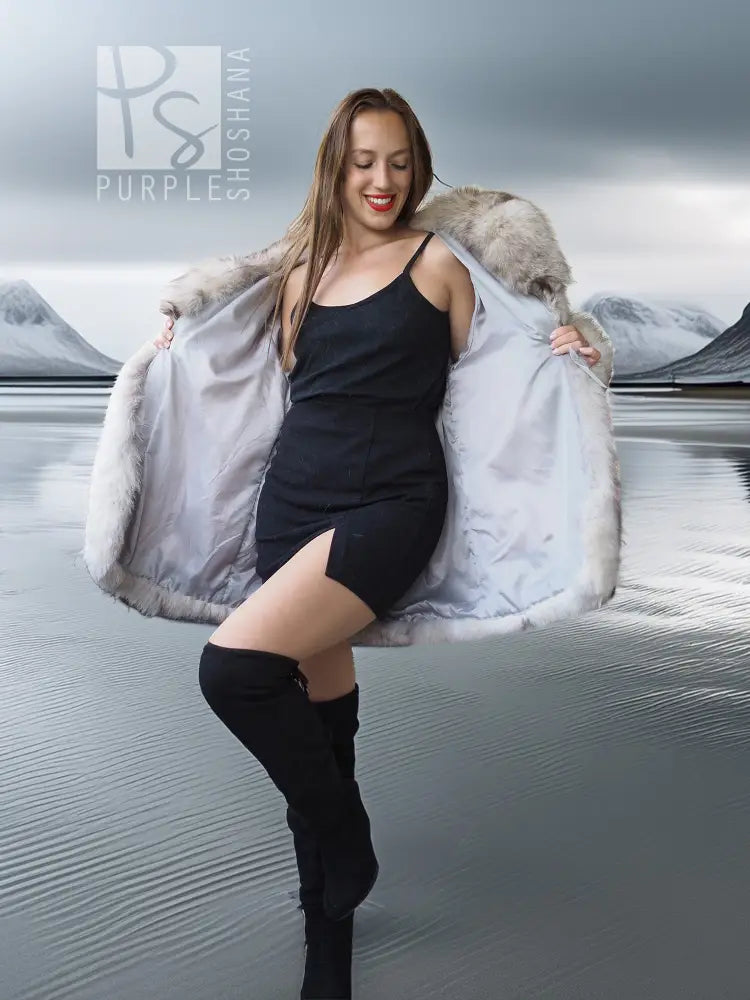 Light gray fur coat with sculptural collar, open front worn over black dress