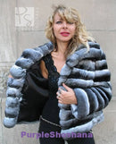 Hooded dark gray fur jacket worn over black top, open front
