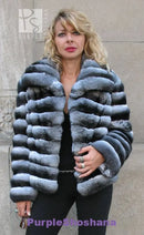 Front view of dark gray hooded fur jacket with chunky horizontal stripes
