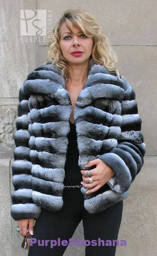 Front view of dark gray hooded fur jacket with chunky horizontal stripes