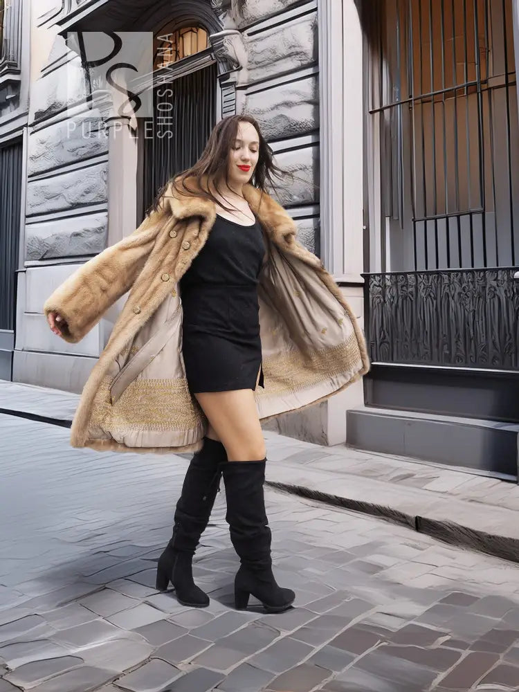 Beige mink fur coat, open-front style with button details and stand collar; black dress.