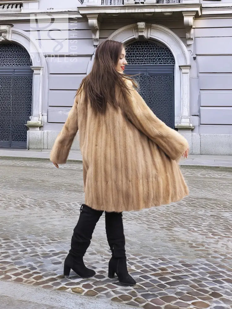 Beige mink fur coat shown from the back, full length with long sleeves.