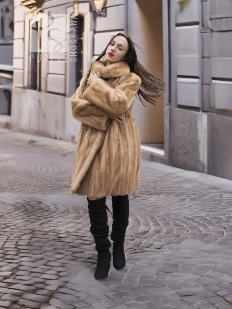 Beige mink fur coat with button front and high collar; full-length sleeves visible.