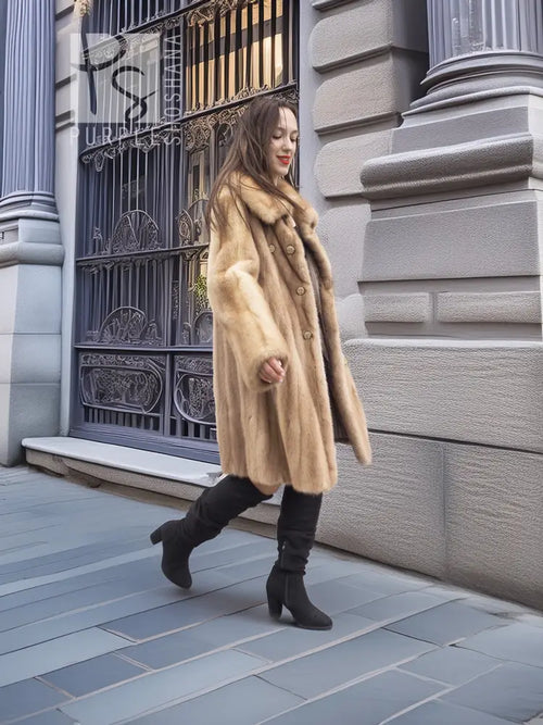 Beige mink fur coat with button front, stand collar, and long sleeves; mid-calf length.