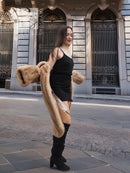 Beige mink fur coat with long sleeves and open front over a black slip dress.