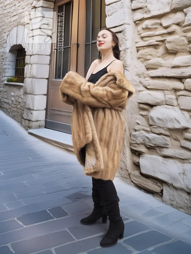 Beige mink fur coat with open collar detail and button-front, full length.