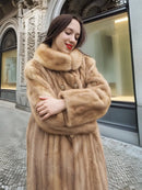 Beige mink fur coat close-up with high collar and button-front detail.
