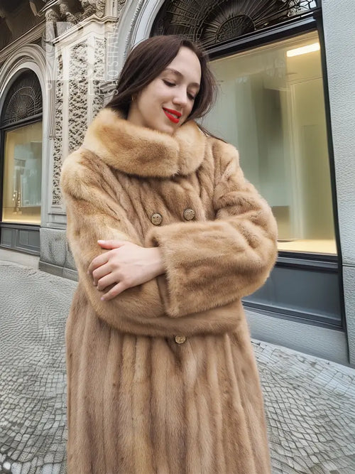 Beige mink fur coat close-up with high collar and button-front detail.