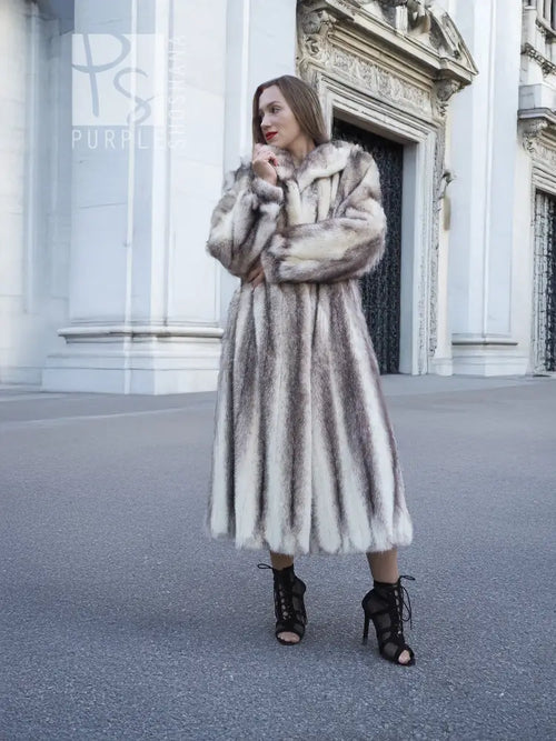 Hooded long mink fur coat with cross-stripe pattern and belted waist, front view.