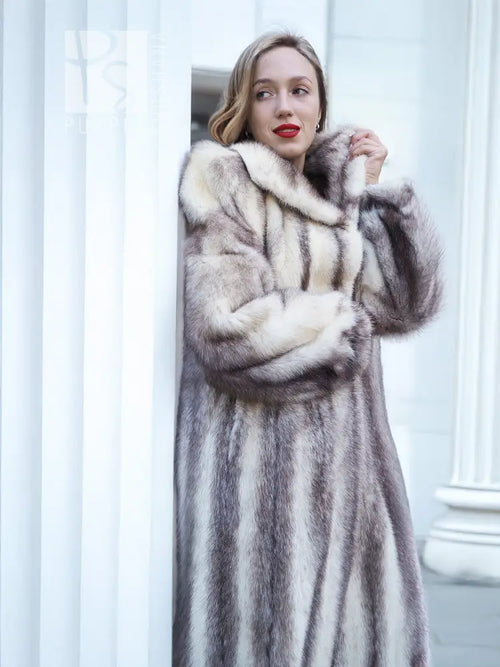 Hooded mink fur coat with cross-stripe pattern and front closure, close-up view.