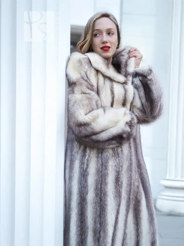Hooded mink fur coat with cross-stripe pattern and front closure, close-up view.