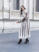 Front three-quarter view of a hooded mink fur coat, mid-calf length and long sleeves