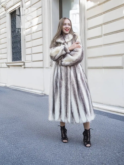 Hooded long mink fur coat with cross-stripe pattern, front view with relaxed arms.